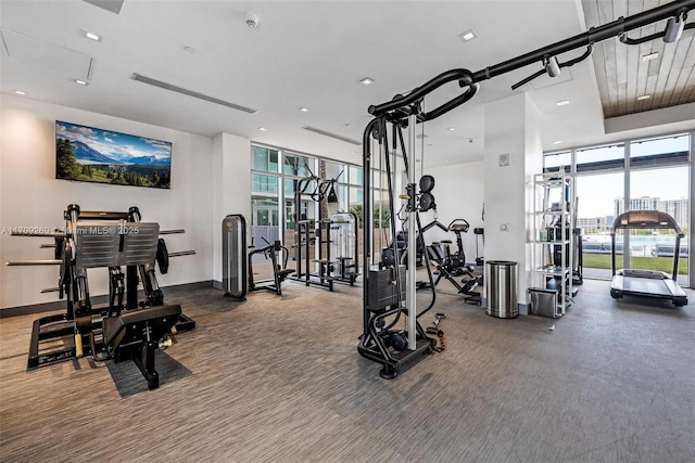 exercise room with baseboards, floor to ceiling windows, and recessed lighting