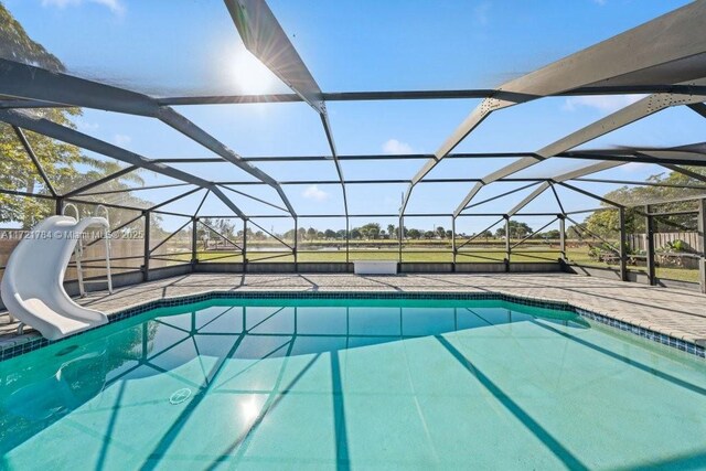 11340 SW 1st St, Coral Springs, FL 33071 - outdoor pool featuring a patio area, a water slide, and a lanai