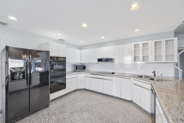 11340 SW 1st St, Coral Springs, FL 33071 - kitchen with white cabinets, a sink, and black appliances