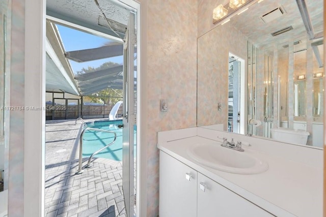 11340 SW 1st St, Coral Springs, FL 33071 - bathroom with toilet, brick floor, vanity, and visible vents