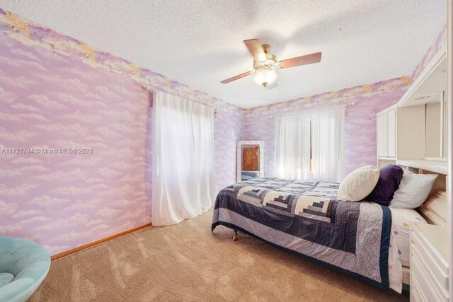 11340 SW 1st St, Coral Springs, FL 33071 - bedroom featuring baseboards, wallpapered walls, a textured ceiling, ceiling fan, and carpet