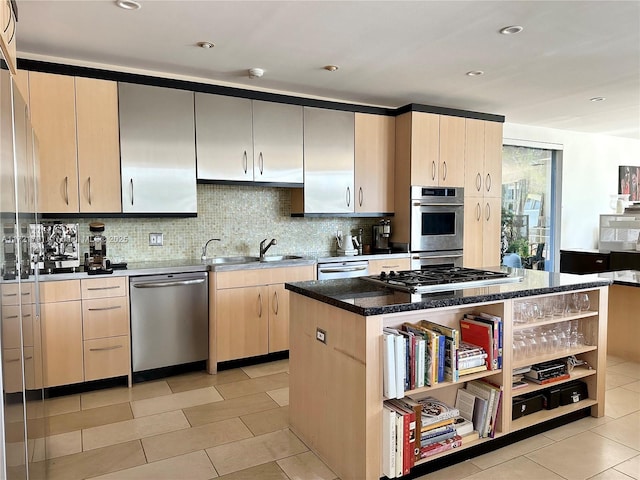 kitchen with decorative backsplash, stainless steel appliances, sink, light tile patterned floors, and a kitchen island