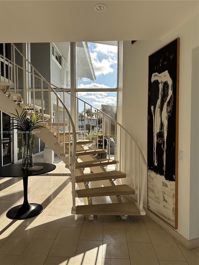 staircase with tile patterned floors