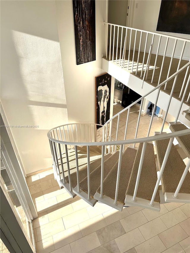 staircase featuring tile patterned flooring