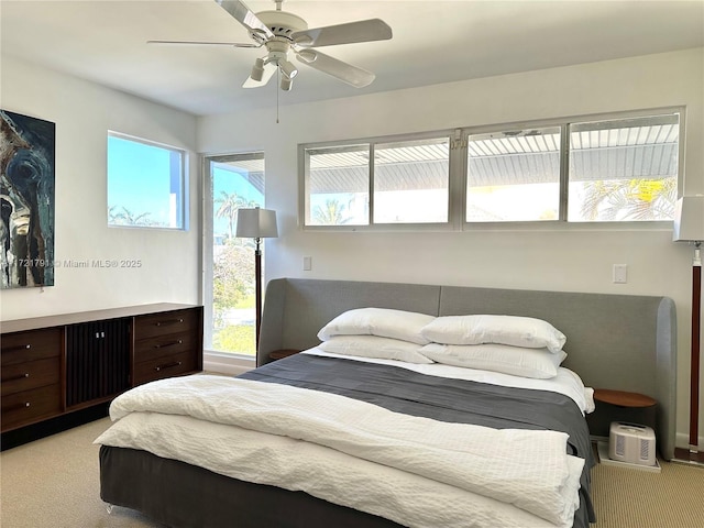 carpeted bedroom with ceiling fan