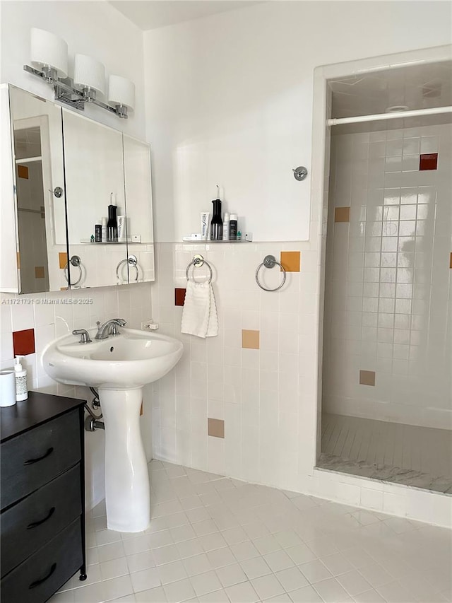 bathroom with tile patterned flooring, tile walls, and tiled shower