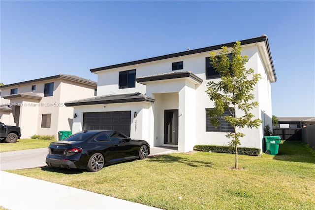 view of front of home with a front yard and a garage