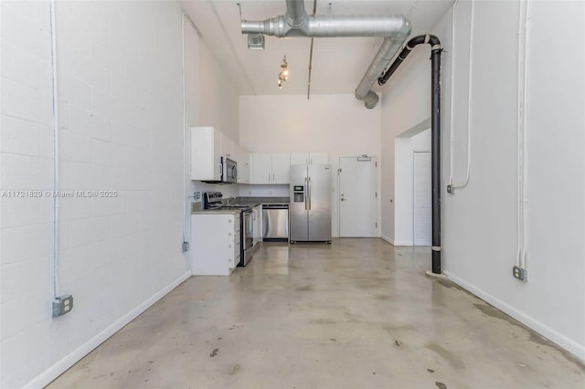 garage with stainless steel fridge with ice dispenser