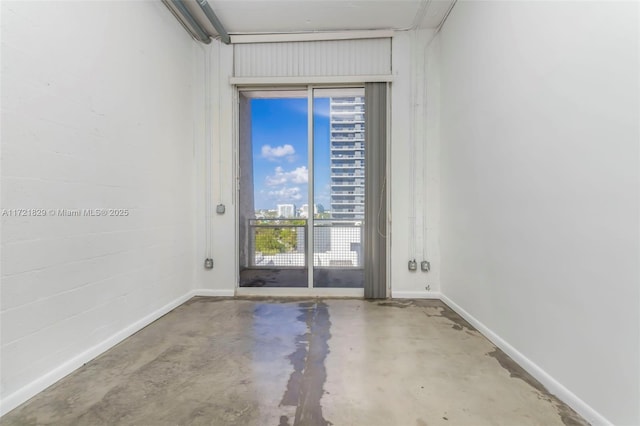 unfurnished room featuring concrete floors