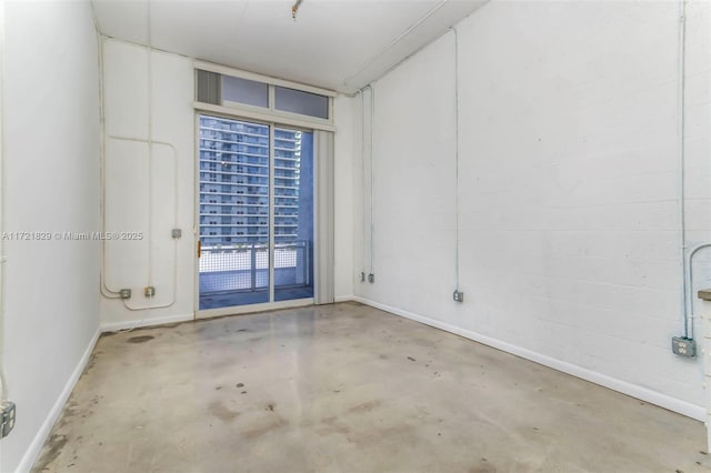 unfurnished room with concrete floors