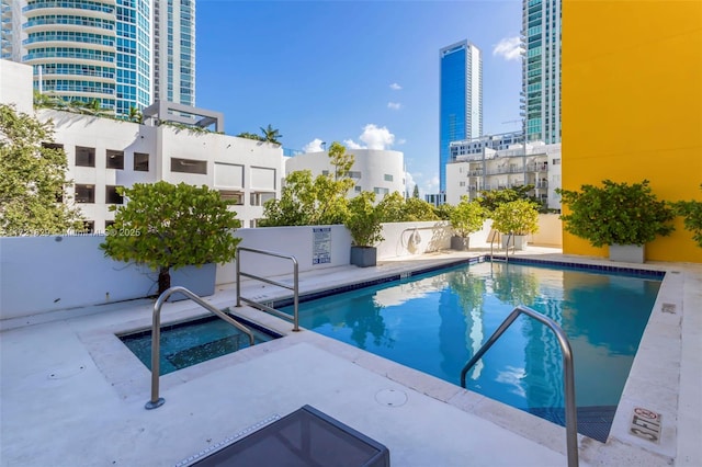 view of pool with a patio area and a community hot tub