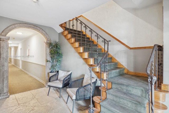 stairway featuring carpet and ornamental molding