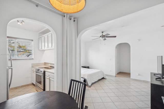 kitchen with ceiling fan, light tile patterned floors, and appliances with stainless steel finishes