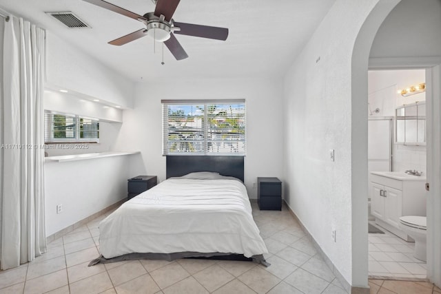 bedroom featuring ceiling fan, light tile patterned flooring, sink, and connected bathroom