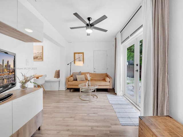 living room featuring french doors, light hardwood / wood-style flooring, and ceiling fan