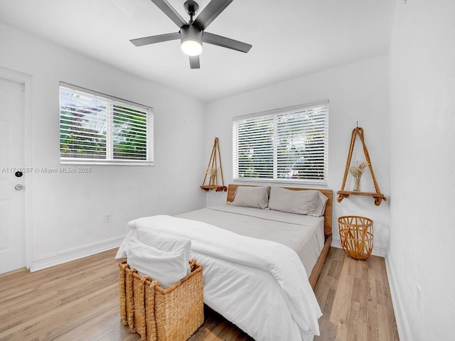 bedroom with light hardwood / wood-style floors and ceiling fan