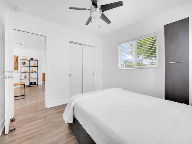 bedroom with ceiling fan, a closet, and light wood-type flooring