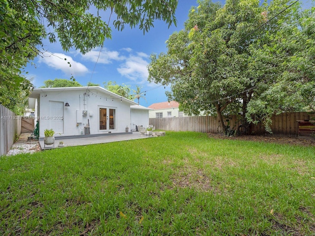 rear view of property featuring a patio and a lawn