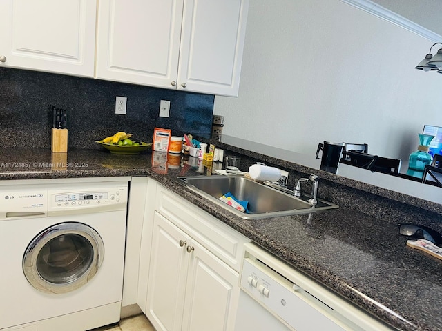 laundry area with ornamental molding, cabinet space, a sink, and washer / dryer