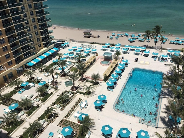 drone / aerial view with a beach view and a water view