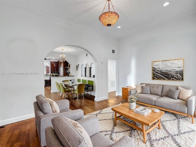 living room featuring wood-type flooring and crown molding