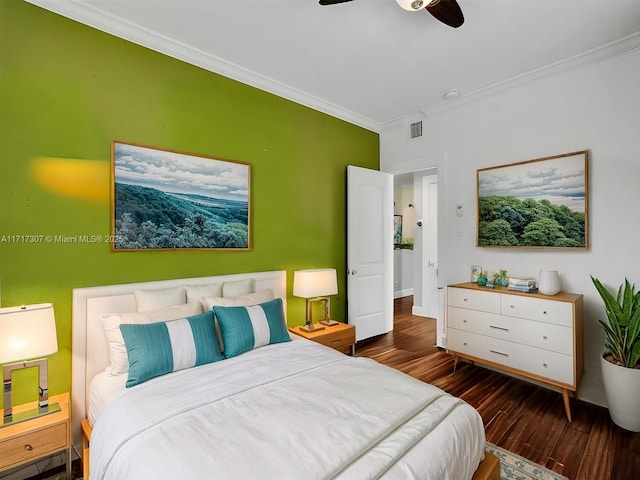 bedroom with dark hardwood / wood-style flooring, ceiling fan, and ornamental molding