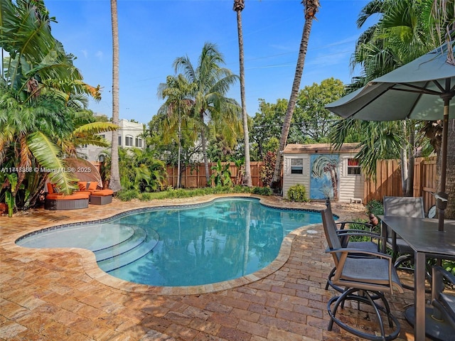 view of pool featuring an outdoor structure and a patio