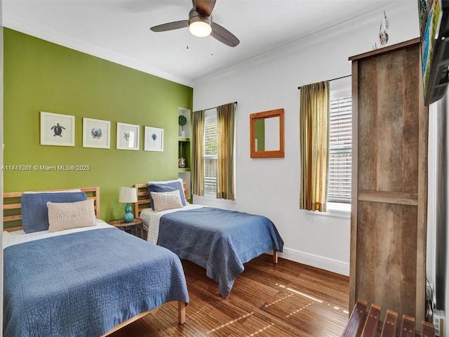 bedroom with ceiling fan, crown molding, and dark hardwood / wood-style floors