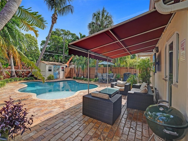 view of swimming pool featuring a patio area, outdoor lounge area, and a storage unit