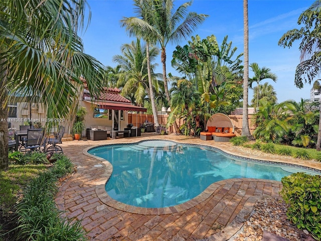 view of pool featuring an outdoor fireplace and a patio