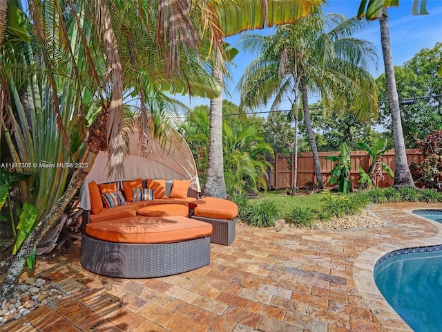 view of patio / terrace with a fenced in pool