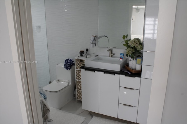 bathroom featuring vanity and toilet