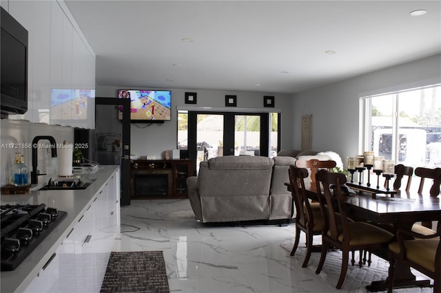 dining area featuring french doors and sink