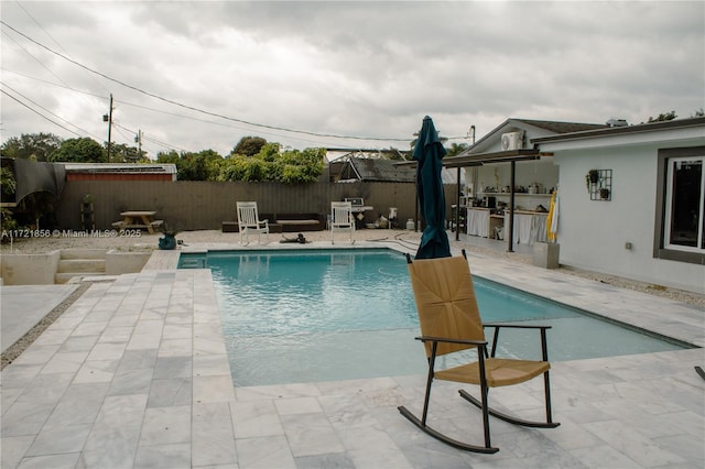 view of pool with a patio area and area for grilling