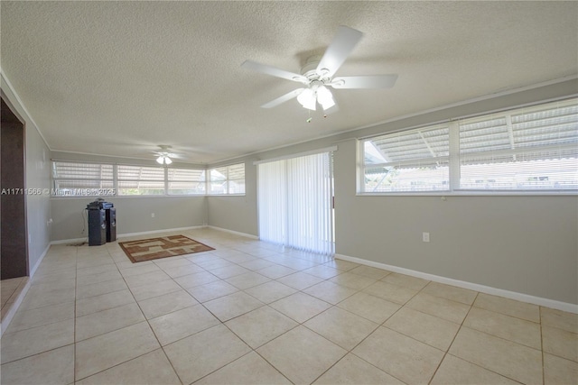 tiled spare room with a textured ceiling and ceiling fan