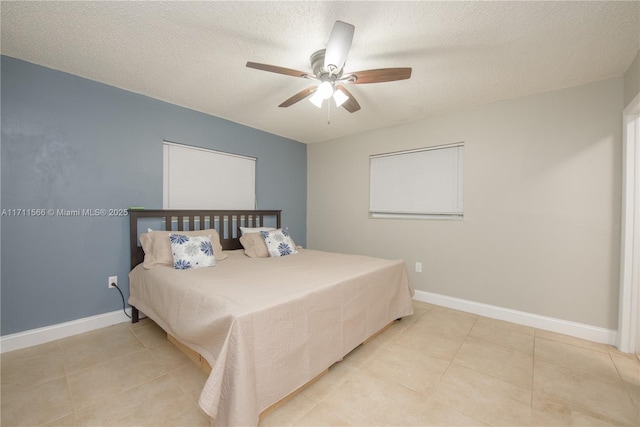 tiled bedroom with ceiling fan and a textured ceiling