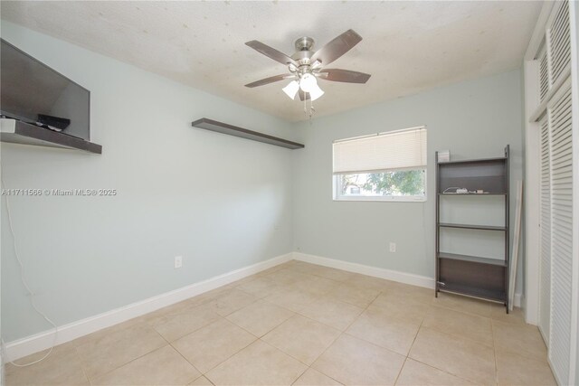 bedroom with ceiling fan and light tile patterned flooring