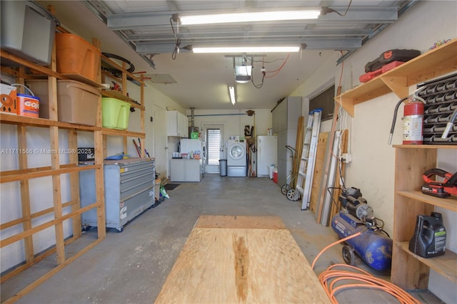 garage with washer / dryer, a garage door opener, and water heater