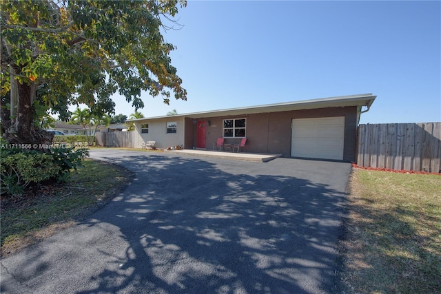 ranch-style house featuring a garage