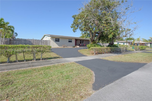 ranch-style home with a front yard