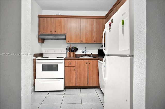 kitchen featuring white appliances, sink, and light tile patterned floors