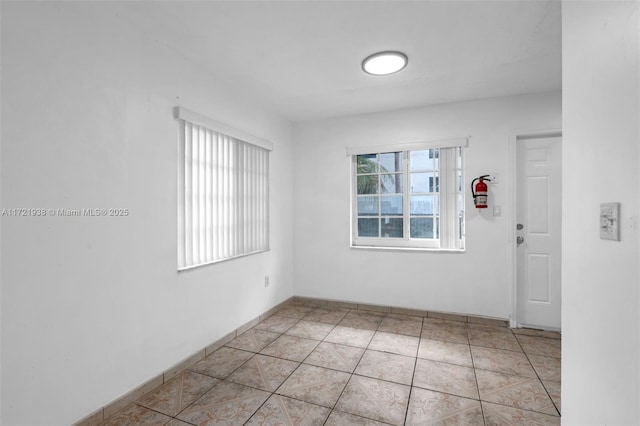 unfurnished room with light tile patterned floors