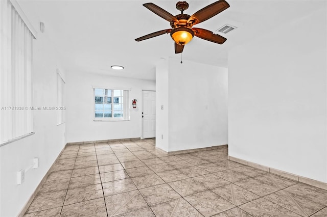 empty room featuring ceiling fan and light tile patterned floors