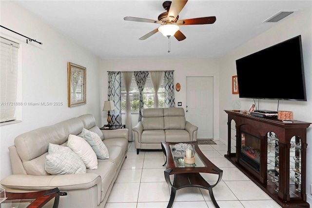 tiled living room featuring ceiling fan