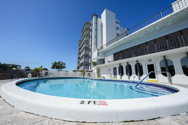 view of swimming pool with fence