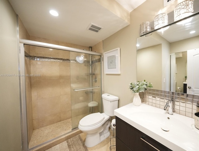 full bathroom featuring visible vents, toilet, a shower stall, decorative backsplash, and vanity