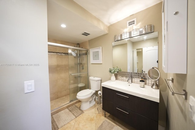 bathroom with a shower stall, visible vents, and backsplash