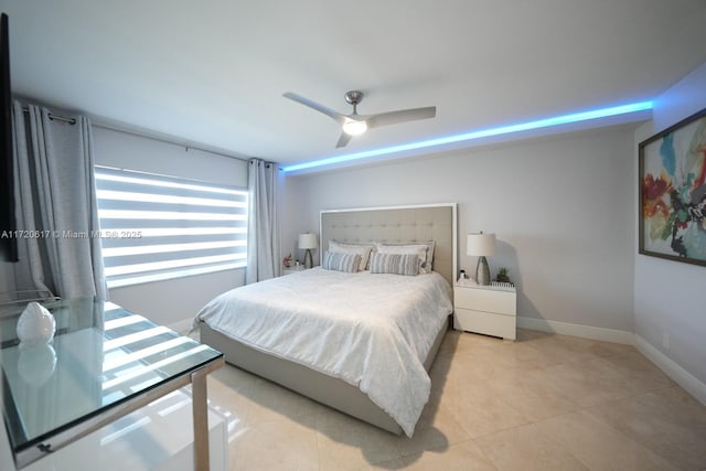 bedroom featuring light tile patterned flooring, baseboards, and ceiling fan