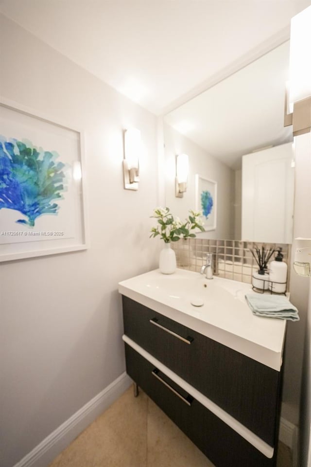 bathroom featuring vanity and backsplash