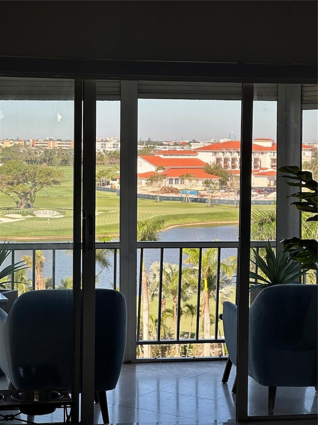 sunroom / solarium featuring a water view